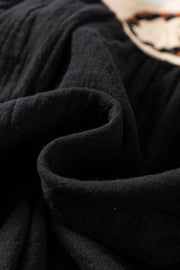 Black gauze blouse with crochet yoke detail and puff sleeves.