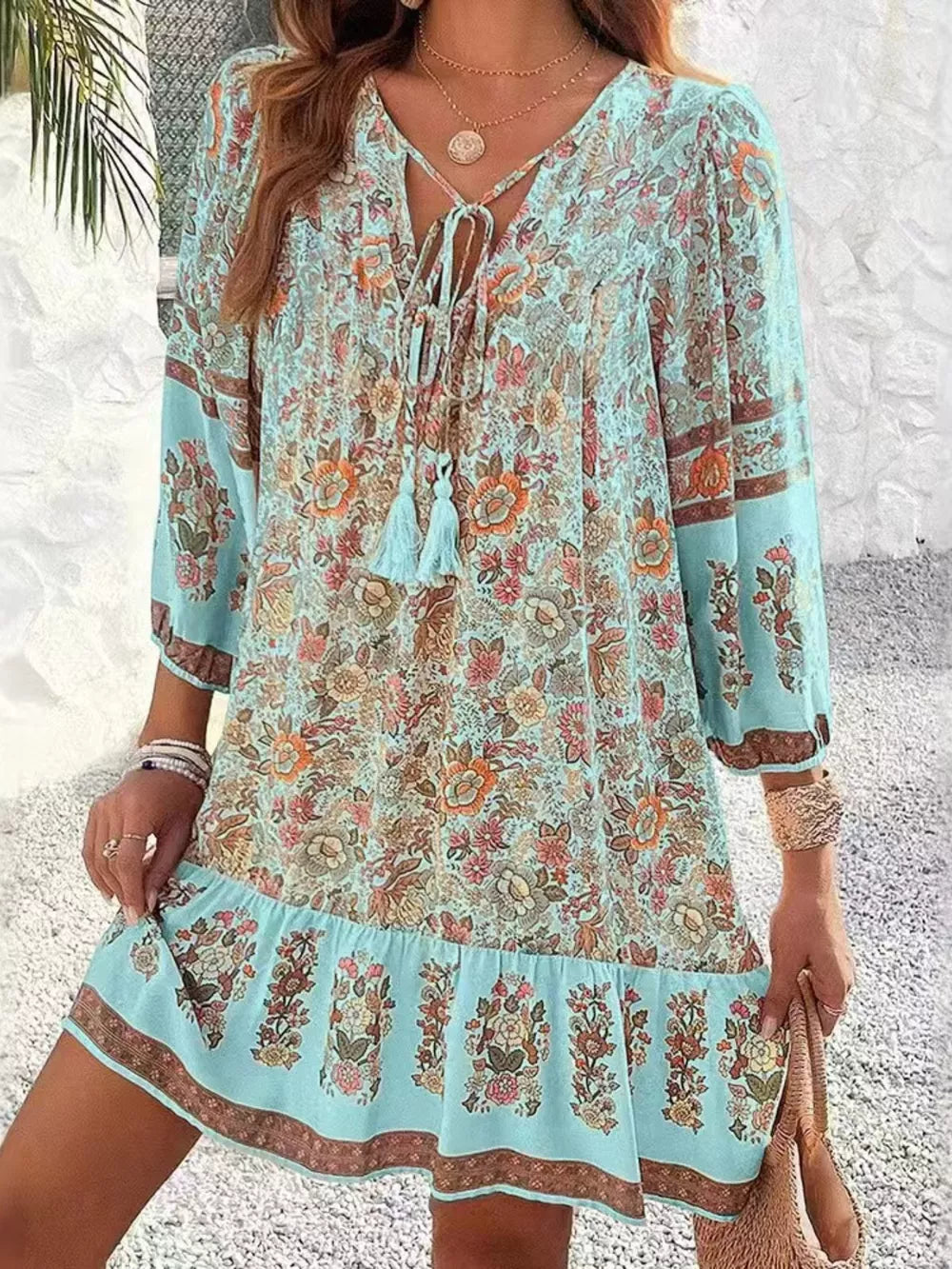 Light blue floral print mini dress with tassel tie neckline and tiered hem