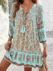 Light blue floral print mini dress with tassel tie neckline and tiered hem