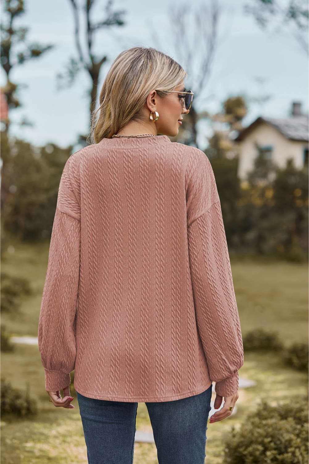 Textured cable knit sweater in Dusty Pink with long sleeves and a V-neck.