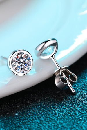 Silver stud earrings with round-cut clear stones and secure backings.