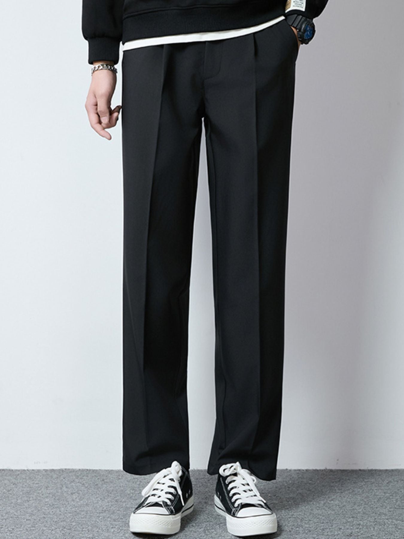 Men's black wide-leg casual pants with a relaxed fit and pleats.