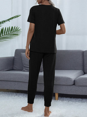 Black relaxed-fit tee and jogger set with short sleeves and crew neck.