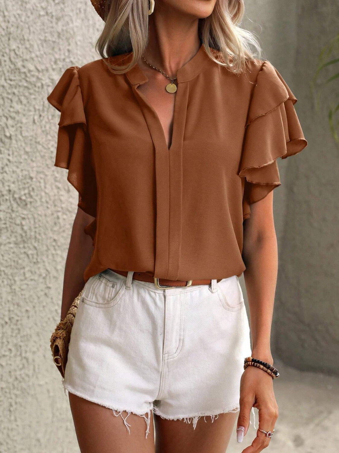 Brown ruffled sleeve blouse with plunge neckline and V-neck detail.
