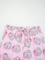 Pink pajama pants with a festive Santa Claus print and drawstring waist.