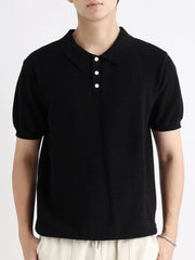 Black cotton short-sleeve polo shirt with button detail and textured knit