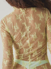 Sheer lime floral lace mock neck blouse with long sleeves.