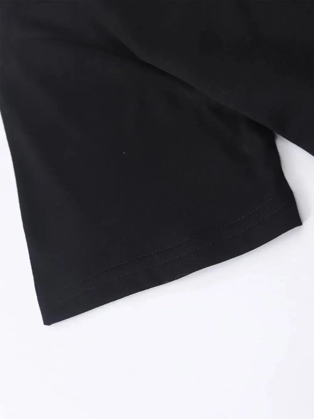 Black t-shirt detail showing hem stitching