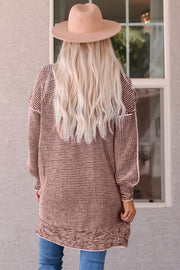 Pink textured puff sleeve open cardigan with a patterned knit and balloon sleeves.