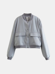 Boxy bomber jacket in light blue with two chest pockets and ribbed collar, cuffs, and hem.