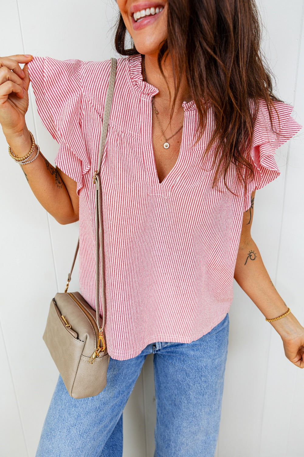 Red and white striped cotton blouse with ruffled butterfly sleeves and a V-neck.