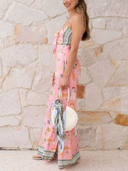 Pink architectural print tie-front wide-leg jumpsuit with bow detail and wide legs.