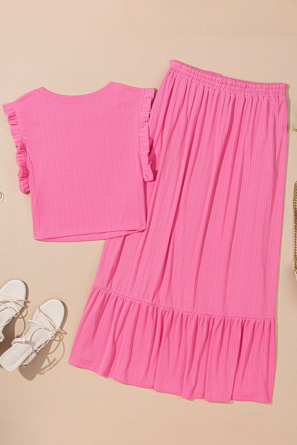 Pink ribbed co-ord skirt set with ruffled cap sleeves and tiered ruffled hem skirt.