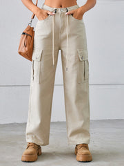 Tan drawstring cargo wide-leg denim trousers with buttoned flap pockets.