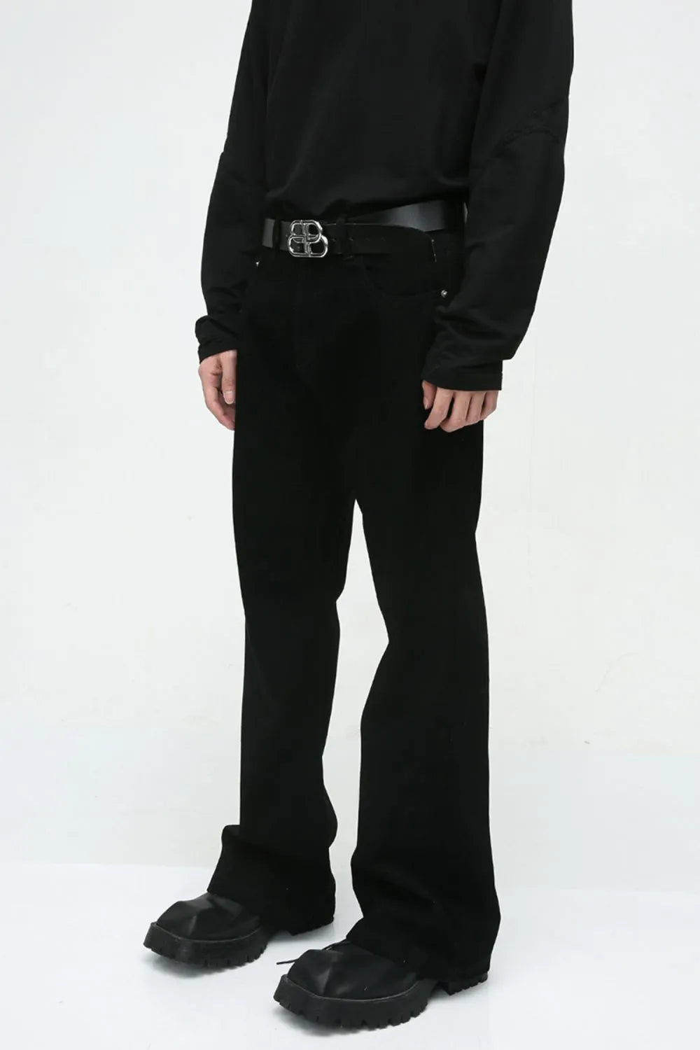 Dark denim bootcut trousers with a classic fit and a black belt.
