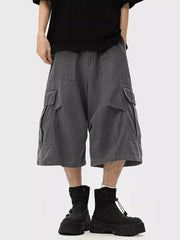 Relaxed fit dark gray cargo cropped sweatpants with multiple pockets.