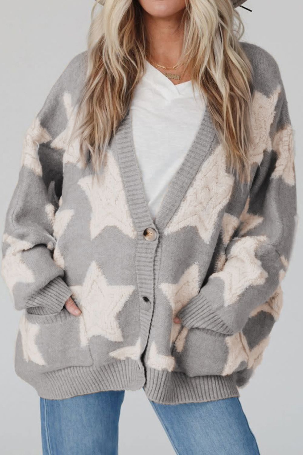 Gray starburst knit cardigan with button front and pockets.