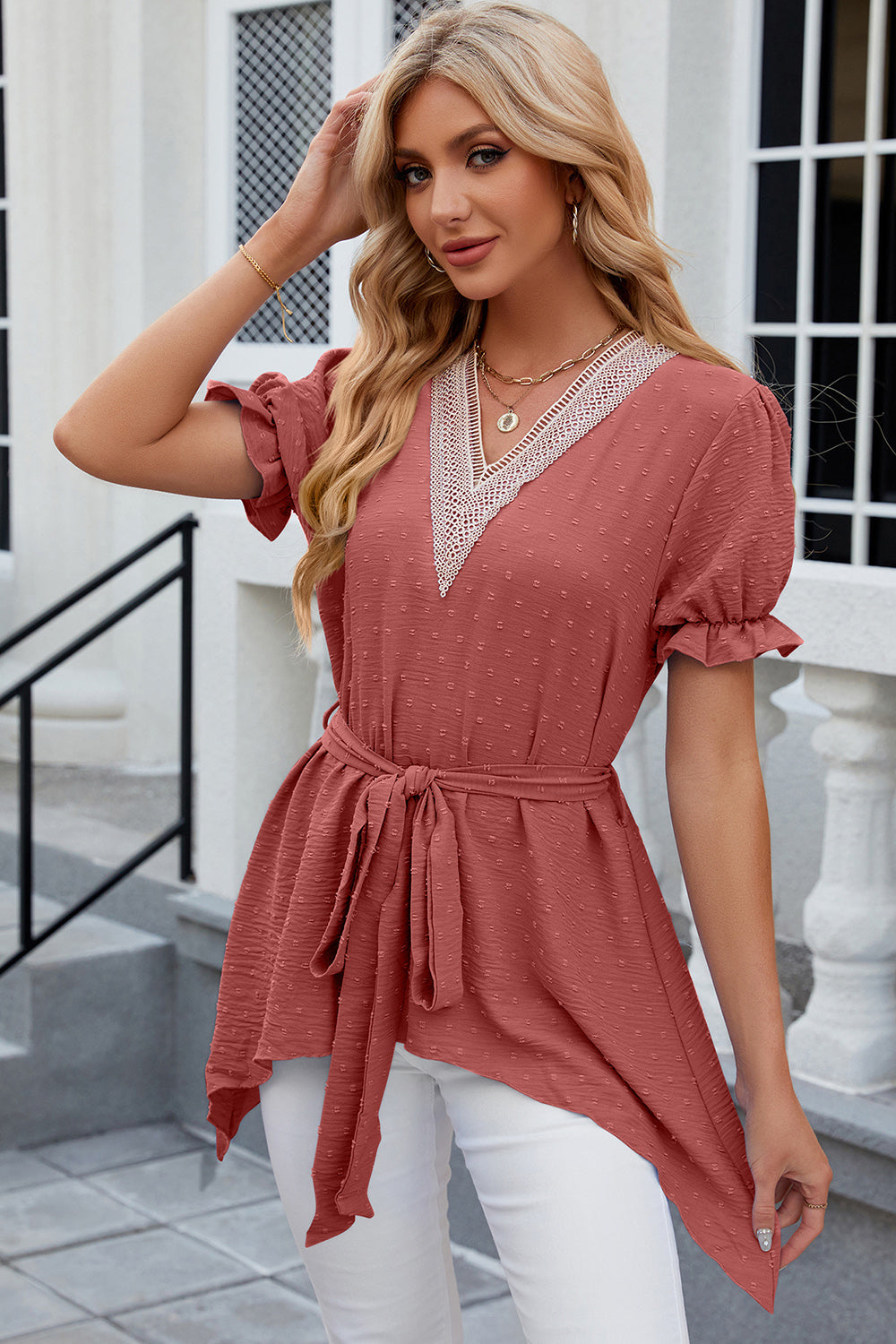 Watermelon pink dotted swiss blouse with lace trim V-neck, tie waist, and asymmetric hem