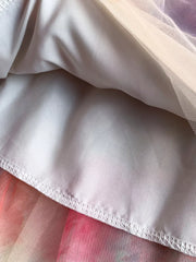 Floral tiered midi dress detail with smocked bodice, showing layered fabric and hem stitching.