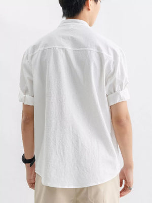Men's white relaxed fit button-up shirt with short sleeves and a chest pocket.