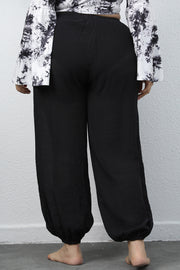 Black textured balloon-leg trousers with drawstring waist and elastic cuffs.