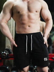 Black performance shorts with white drawstring and logo detail