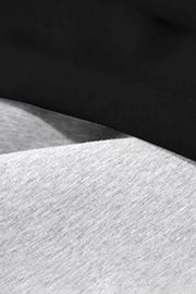 Relaxed-fit lounge trousers in dark gray and black heathered knit fabric.