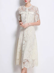 Cream lace buttoned dress with short sleeves and two chest pockets.