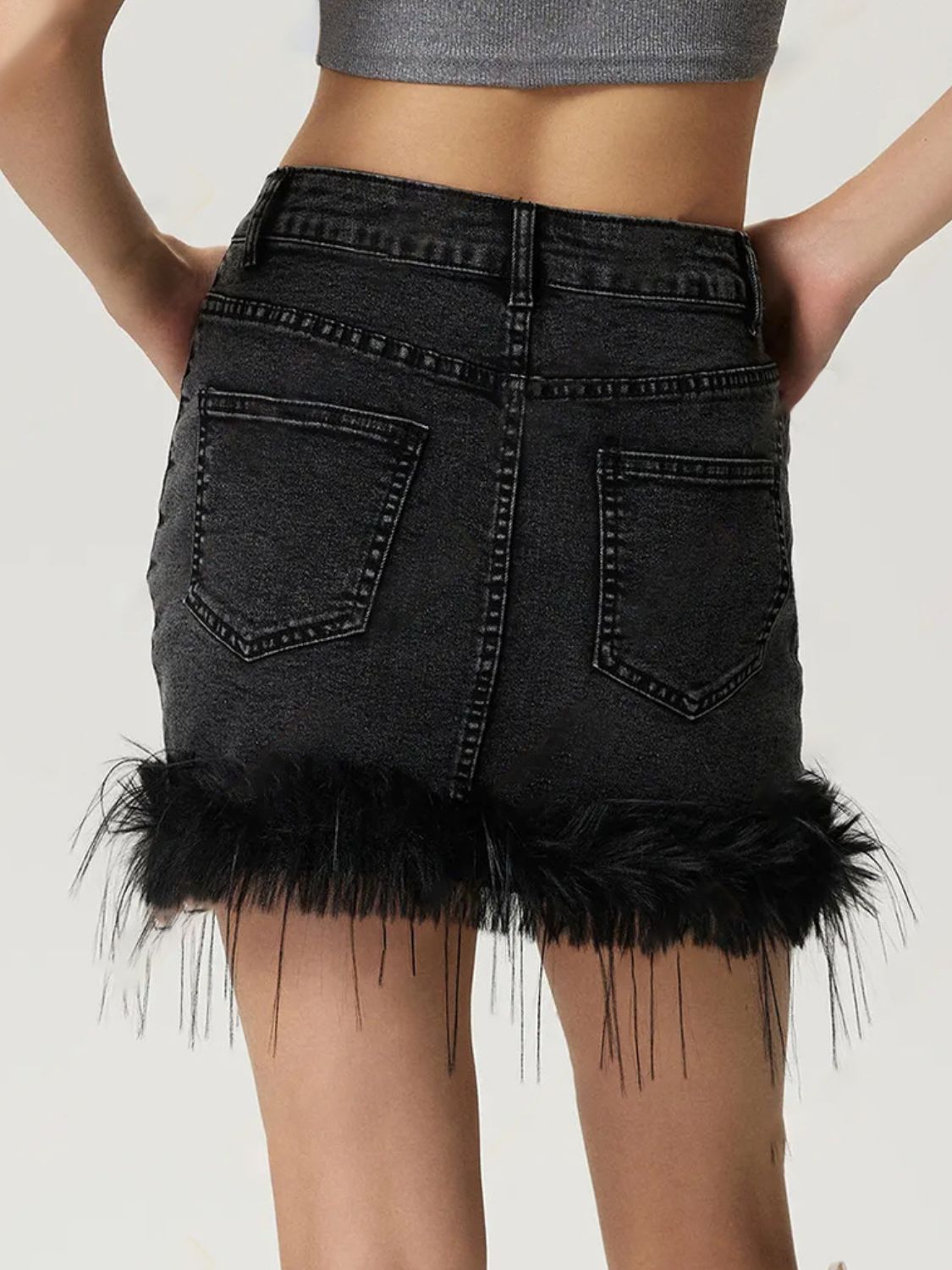 Black denim mini skirt with feather trim hem