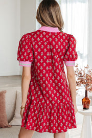 Red floral mini dress with puff sleeves, V-neck, and ruffled hem.