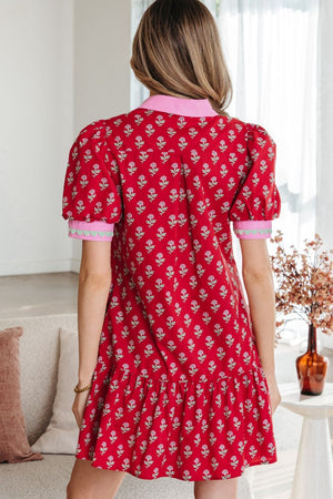 Red floral mini dress with puff sleeves, V-neck, and ruffled hem.