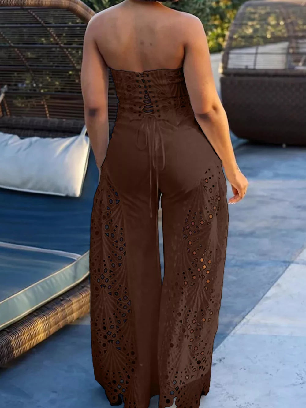 Brown strapless two-piece ensemble with intricate openwork details and lace-up back.