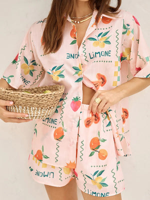 Pink linen co-ord set with a limoncello print, featuring a button-up shirt and shorts.