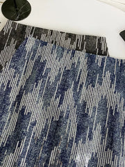 Shimmering sequin mini skirt in dark blue with vertical stripe pattern and zipper detail.
