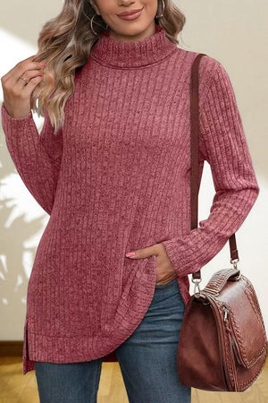 Ribbed knit turtleneck tunic top in Cerise with side slits and a relaxed fit.