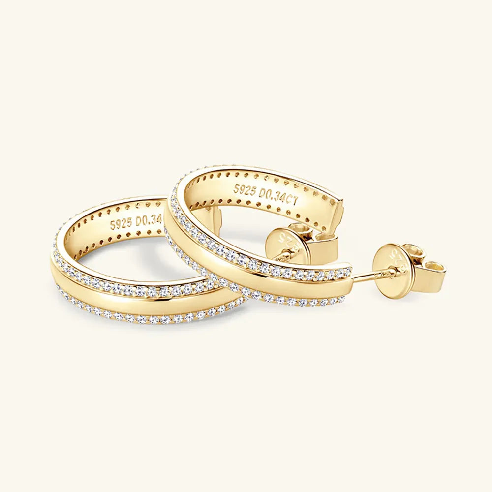 Gold pavé moissanite C-hoops in sterling silver with diamond accents.