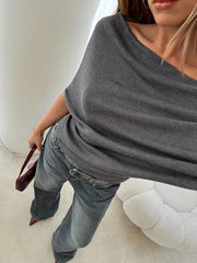 Dark gray ruched off-shoulder knit t-shirt with a draped neckline.