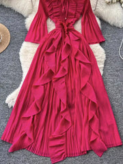 Pink A-line midi dress with cascading ruffles, bell sleeves, and tie neck.