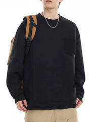 Black crewneck sweatshirt with chest pocket and textured side panel.