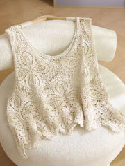 Cream lace overlay cropped vest with floral pattern and scalloped hem.