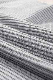 Gray ribbed knit cape sleeve top with a textured stitch detail.