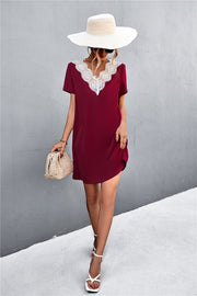 Wine V-neck shift dress with lace trim detail and short sleeves.