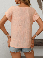 Peach eyelet knit tee with short sleeves and a scoop neck, featuring a diamond pattern.