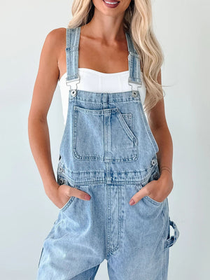 Light wash denim overalls with wide straps, bib pocket, and relaxed fit.