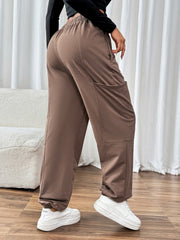 Taupe cargo joggers with elastic waistband and cuffs, and large side pockets.