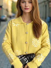 Yellow knit cardigan with pearl buttons and snowflake pattern