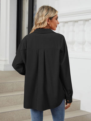 Black corduroy overshirt with buttoned cuffs and back pleat detail.
