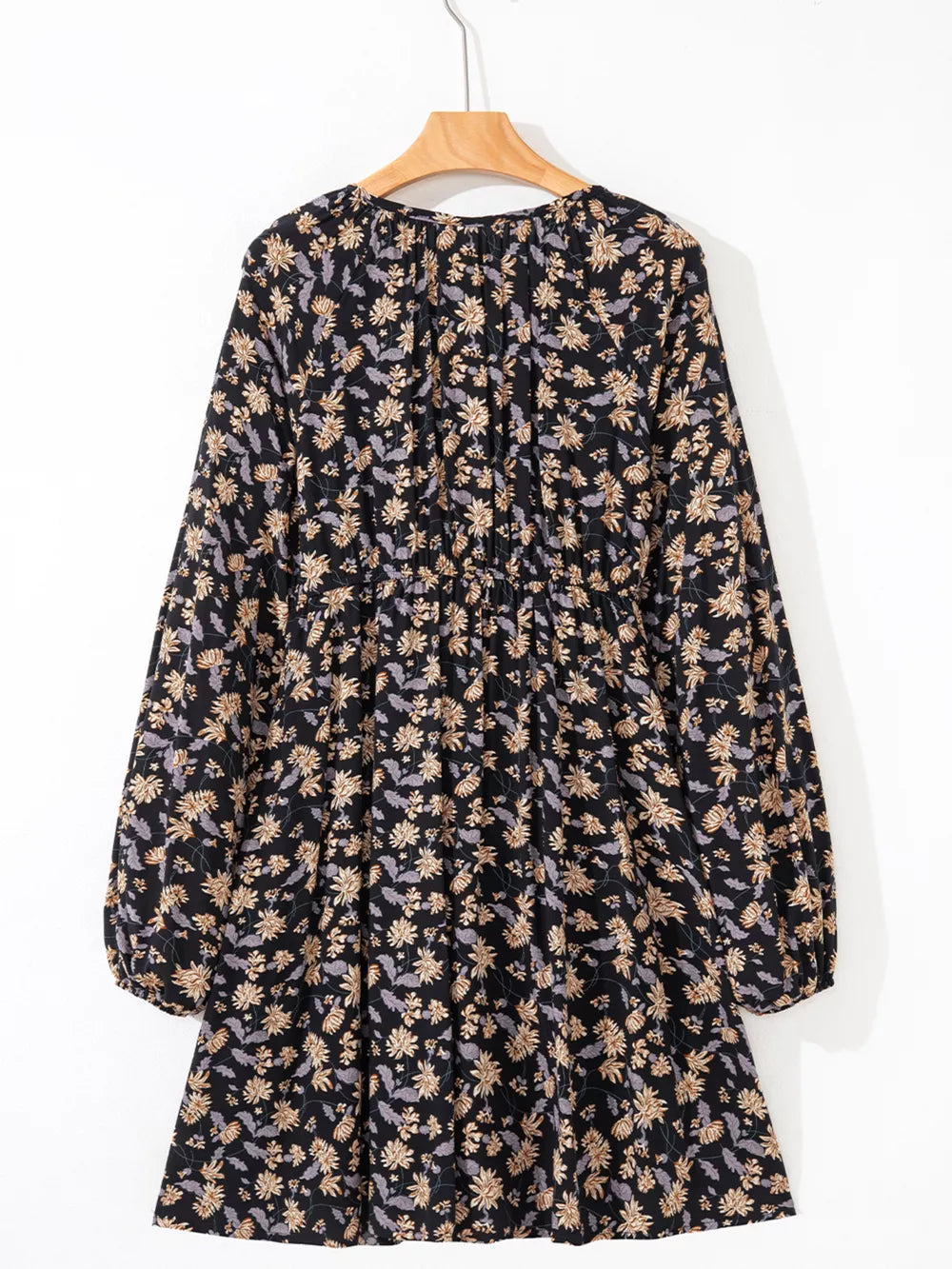 Babydoll dress with dark floral print, bubble sleeves, and gathered waist.