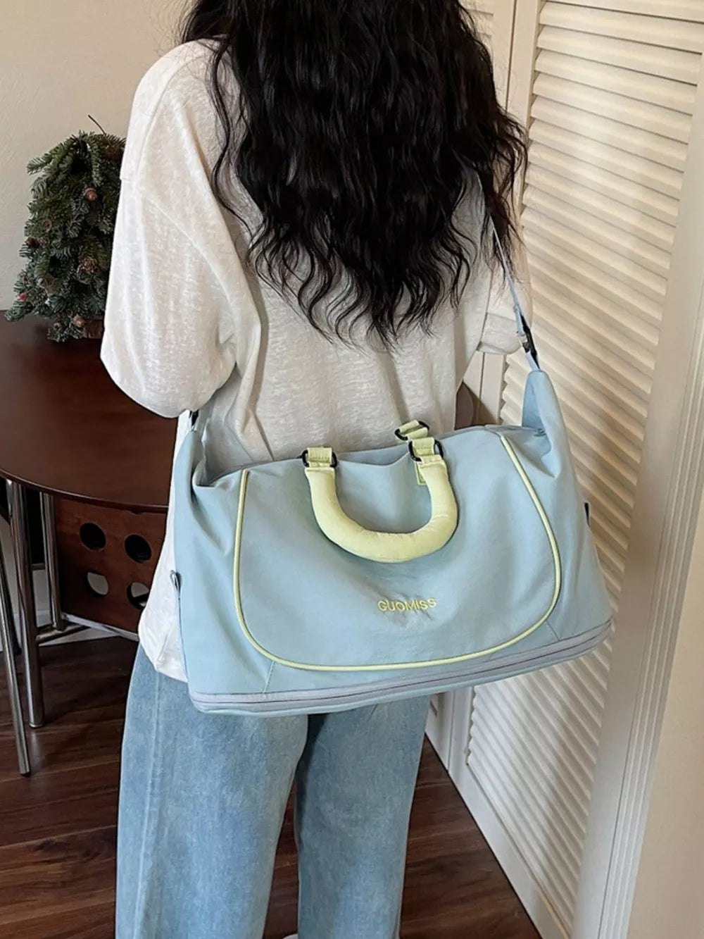 Light blue Oxford cloth duffle bag with yellow trim and handles, perfect for gym or travel.