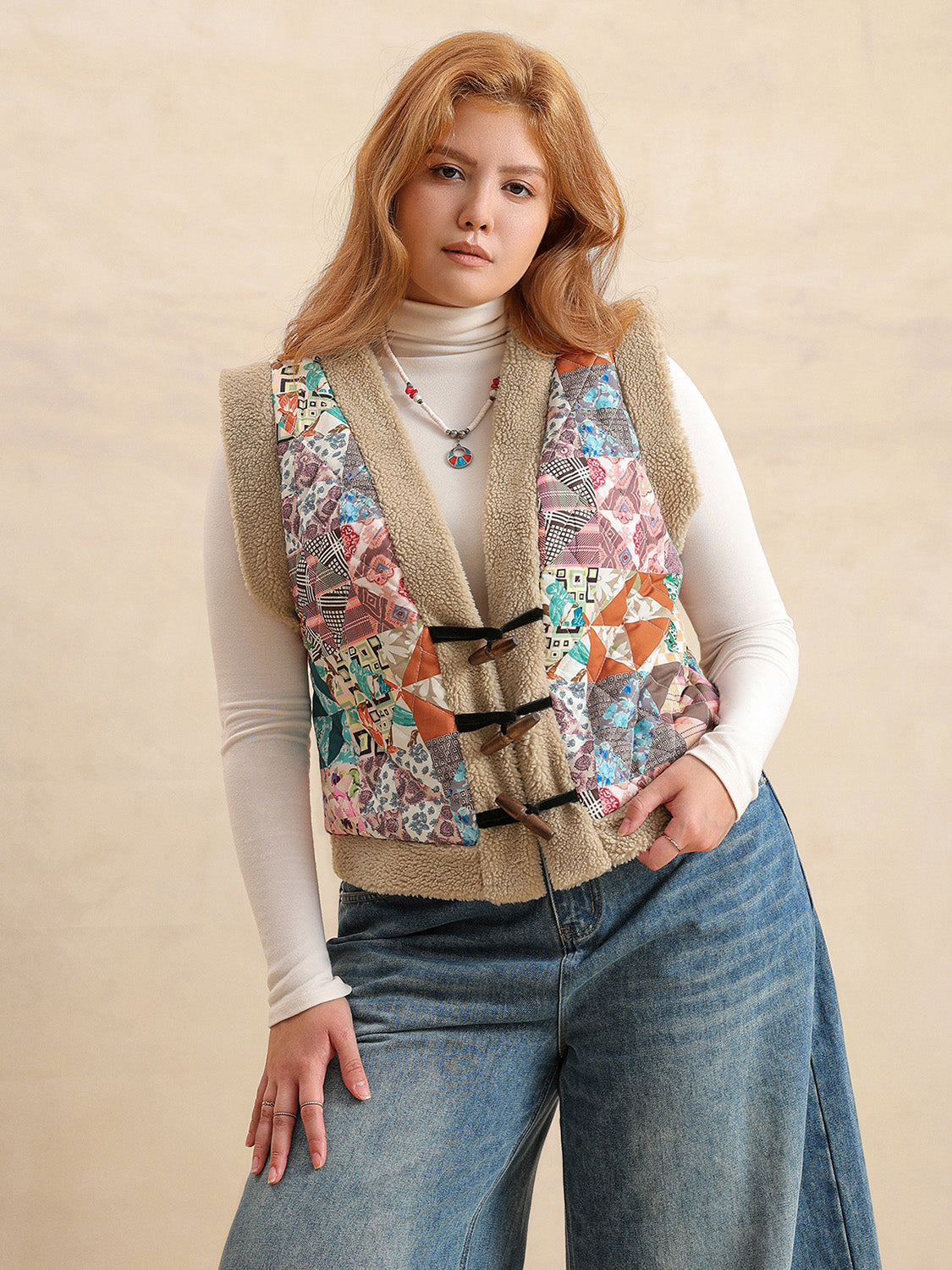 Patchwork sherpa vest with toggle closures and multicolor boho print.